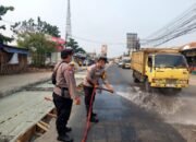 Polsek Pasar Kemis Siram Jalan, Kurangi Dampak Debu Abu Vulkanik Demi Keselamatan Pengendara
